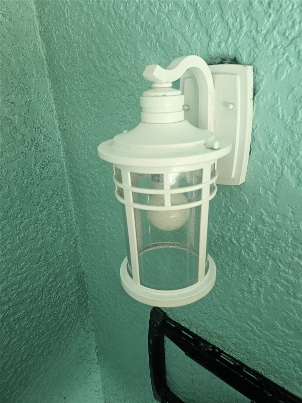 The same outdoor light fixture after cleaning, spotless and restored