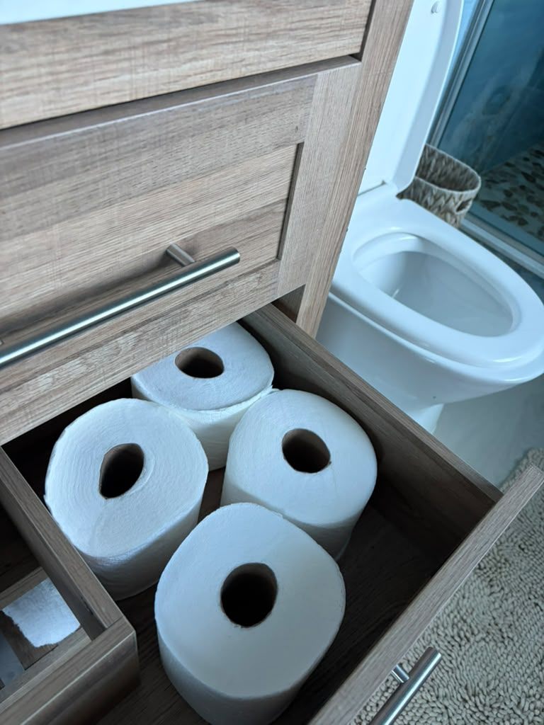 Restocked bathroom supplies staged neatly for the next guest