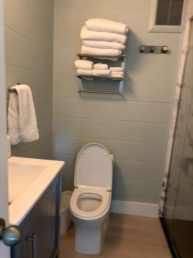 Freshly folded hotel-style towels staged for guest arrival